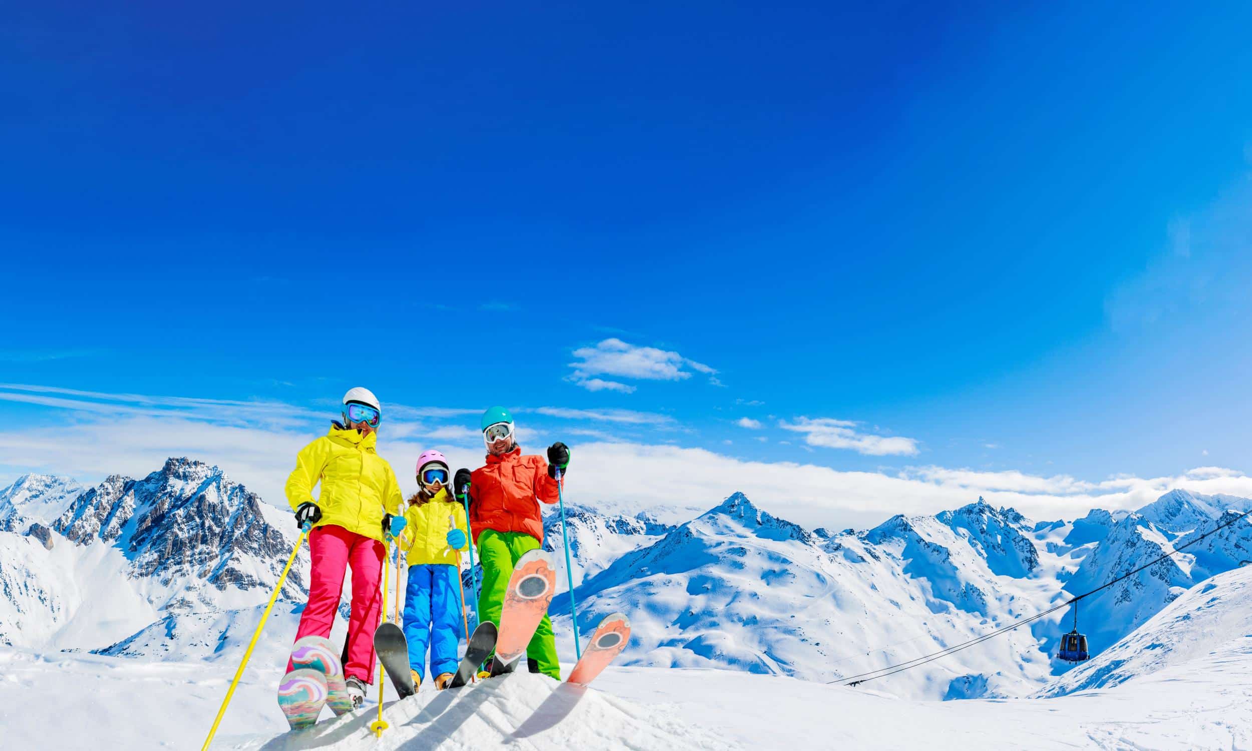Happy family enjoying winter vacations in mountains . Ski, Sun, Club Med Snow All Inclusive Resort