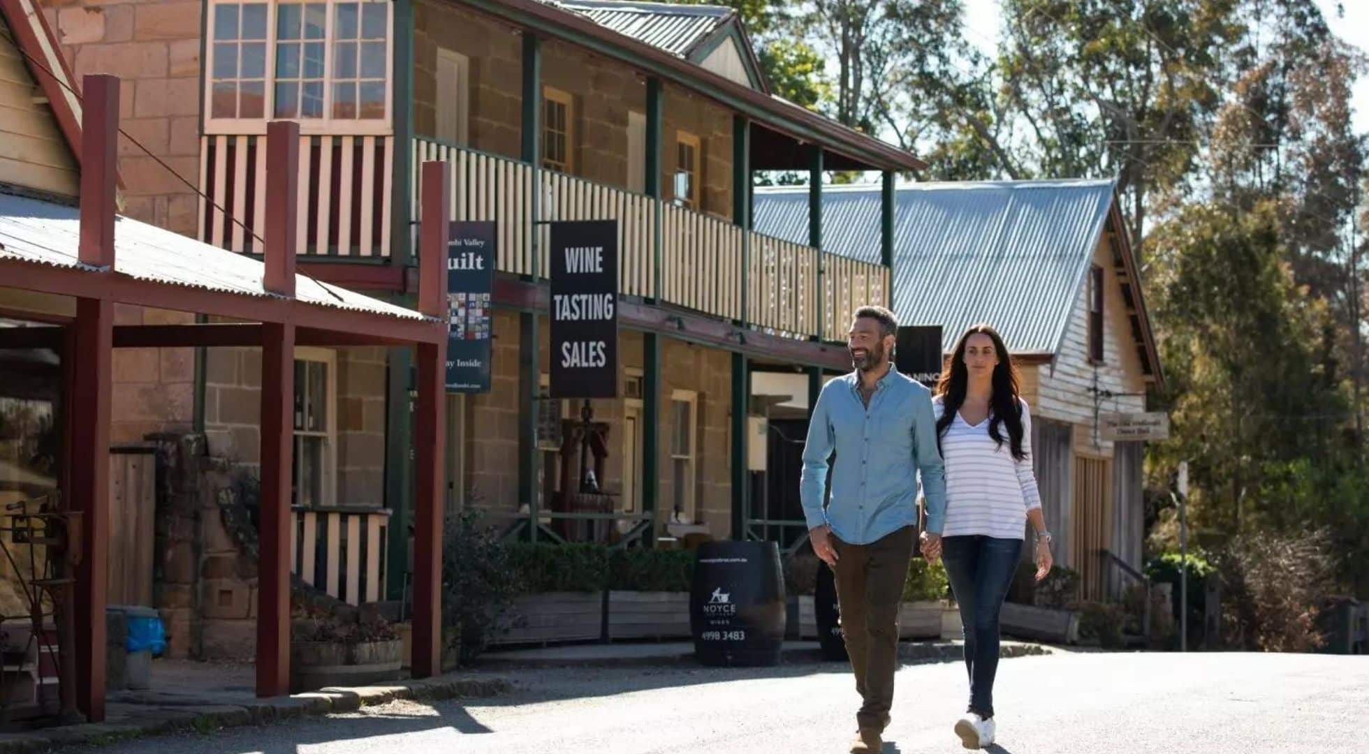 Couple walking through Wollombi, one of the hidden gems in New South Wales.