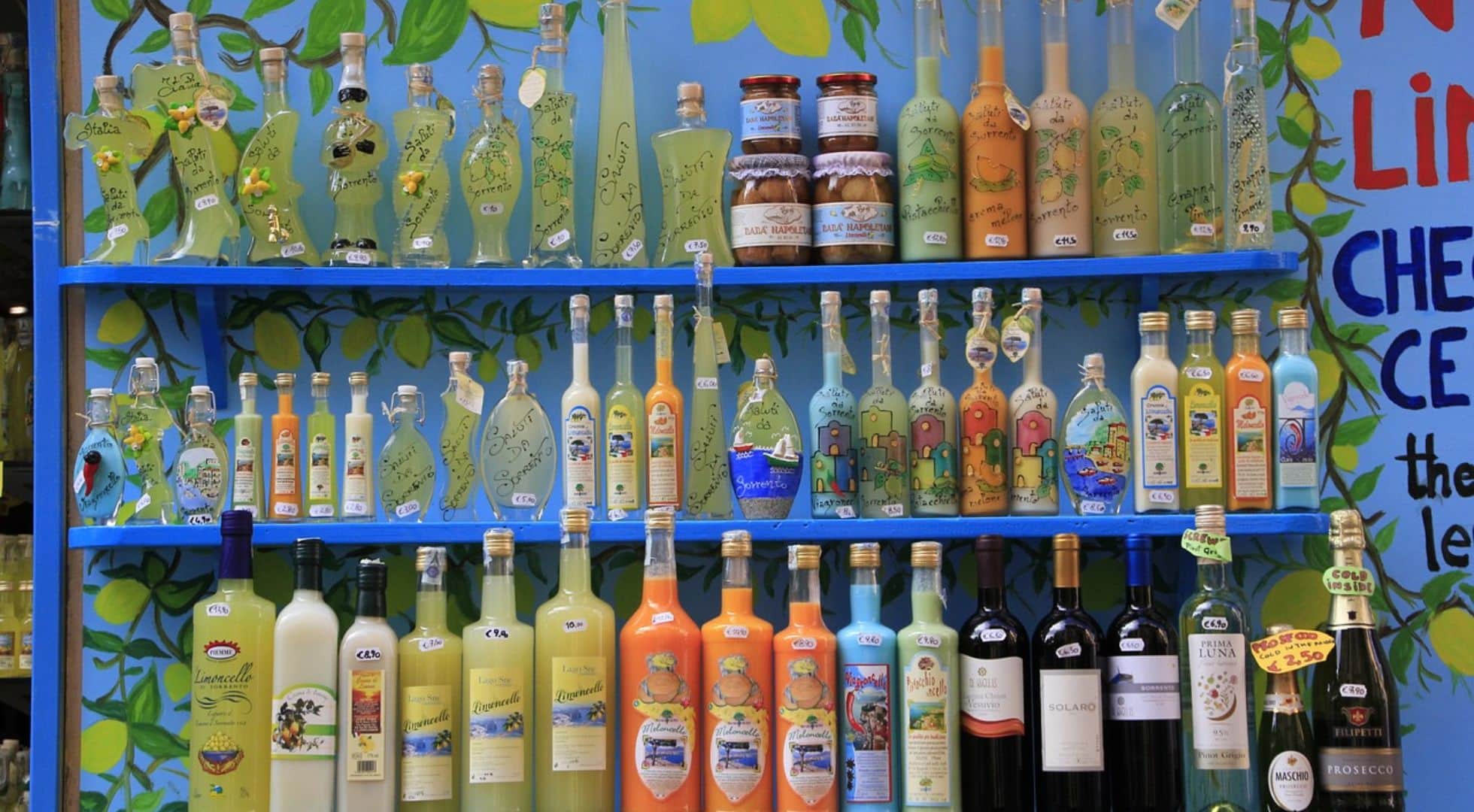 Italy travel guide image of bottles of limoncello liqueur in Sorrento.