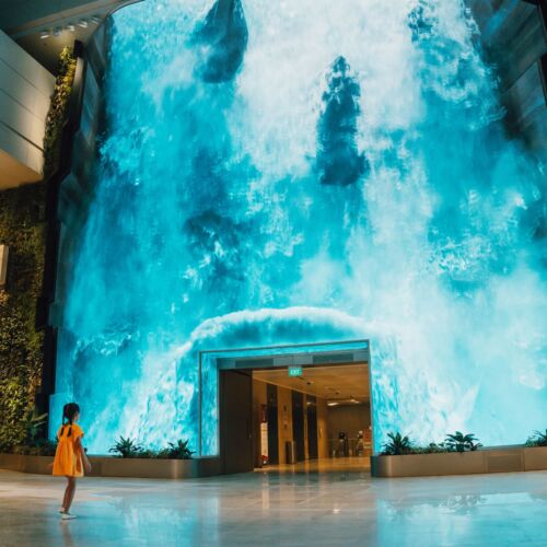 Be transported to a captivating realm as a grand digital waterfall descends at Changi Airport T2's departure hall