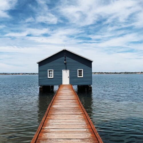 Image is of the blue boat house in Matilda Bay which is a popular landmark highlighted in this Perth solo travel guide.