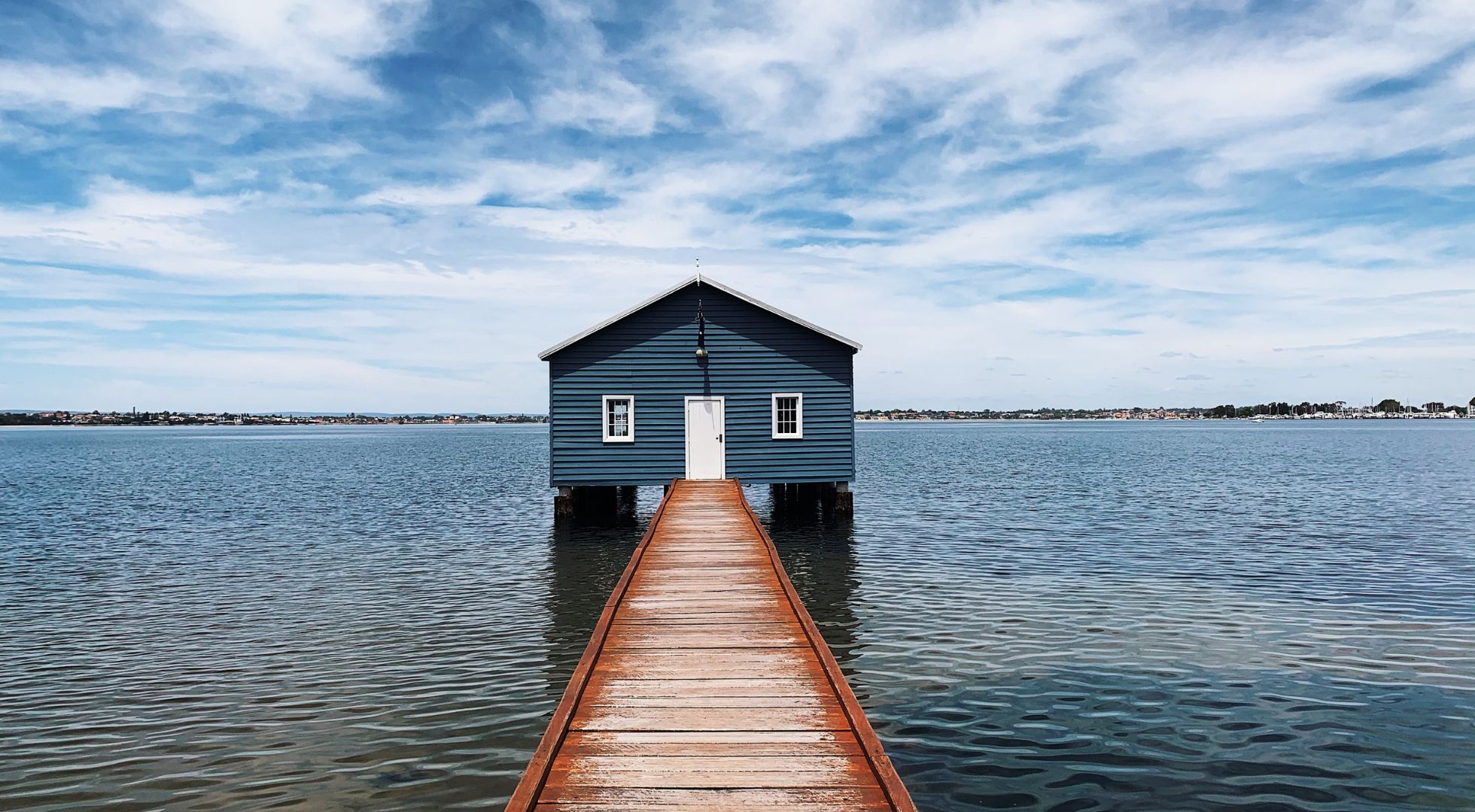Image is of the blue boat house in Matilda Bay which is a popular landmark highlighted in this Perth solo travel guide. 